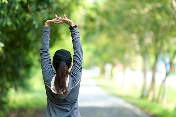 Healthy Woman Warming Up Stretching Her Arms. Asian Runner Woman